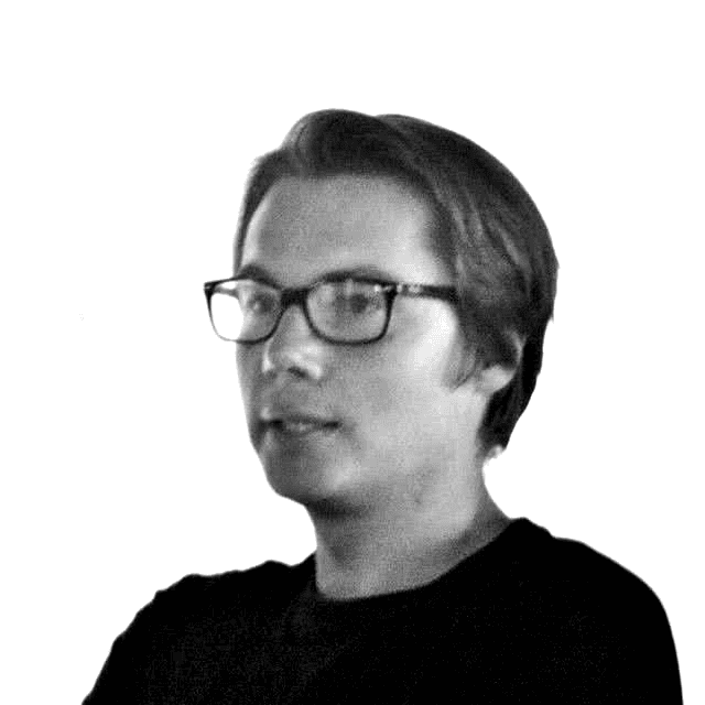 A black and white profile picture of Nick Saperov in glasses and black T-shirt.